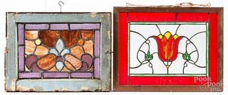 Three small stained glass windows, with another