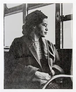 PARKS, ROSA. Black and white photograph of Parks sitting on a bus, signed "Rosa Parks."