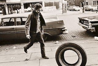 Jim Marshall (American, 1936-2010)      Bob Dylan Kicking Tire, Seventh Avenue, New York City