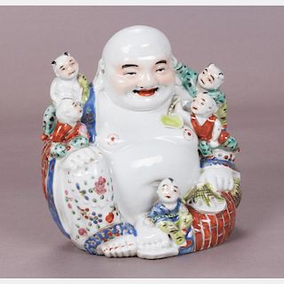 A Chinese Porcelain Figure of Buddha with Five Children, 20th Century.