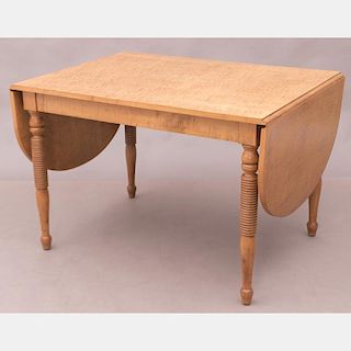 An American Tiger Maple Drop Leaf Table, 20th Century.