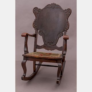 A Victorian Mahogany Rocking Chair with Woven Seat, 19th Century.