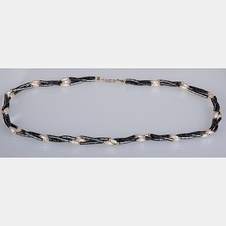 A Hematite, Pearl and Gold Beaded Necklace.