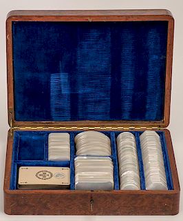 Cased Set of Mother of Pearl Game Markers. French (?), ca. 1890. 25 rectangle plaques, 25 square plaques, 25 oval plaques, 50 round plaques, 50 hexago
