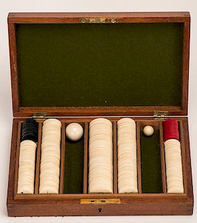 Cased Set of Small Ivory Poker Chips. English, ca. 1885. Including 20 red £10 chips (3/4î), 16 black £20 chips (3/4î), 100 white six-pence chips (