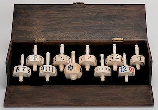 SalesmanÍs Sample Cased Set of Ten Ivory Put & Take Tops. English, ca. 1900. Housed in a vintage wooden double-hinged display box lined with black fe