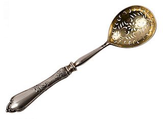A PARCEL GILT SLOTTED SILVER SERVING SPOON, FABERGE WITH IMPERIAL WARRANT, MOSCOW, 1899-1908