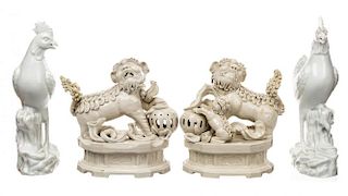 A BLANC-DE-CHINE GROUP OF TWO LIONS AND TWO ROOSTERS