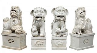 A GROUP FEATURING TWO PAIRS OF BLANC-DE-CHINE LIONS