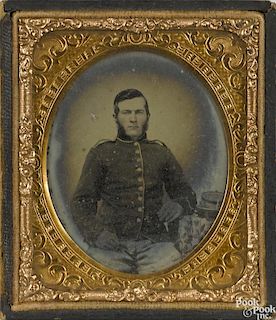 Civil War ambrotype of a Union soldier, ca. 1863, seated with his kepi resting on a side table