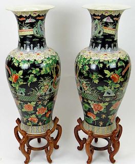 Large Pair of Chinese Famille Noir Baluster Vases with Wood Stands.