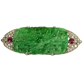 GIA Certified Art Deco Pierced Carved Jade, Round Brilliant Cut Diamond, Ruby and Platinum Brooch. Jade measures 45.23 x 22.87 x 3.80mm.