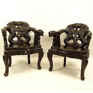 Pair of 20th Century Chinese Carved Wood Dragon Arm Chairs. Inset eyes.