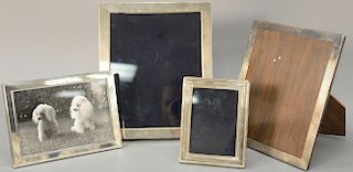 Four sterling silver picture frames including two Carr's silver and two Cartier silver. inside dimensions: 5 1/4" x 3 1/4" to 10" x 8"