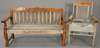 Carved teak bench and armchair, bench having carved birds, flowers, and leaves with slat wood seat along with armchair with rope seat