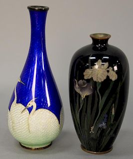 Two cloisonne enameled small vases, one blue with white cranes along base and the other black with blossoming wild flowers