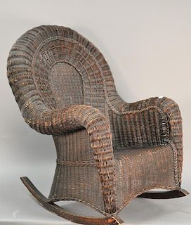 Fancy wicker rocker with rolled arms in natural dark finish, early 20th century.