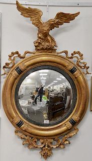 Two contemporary convex mirrors with eagle top, one as is