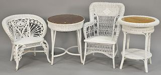 Four piece wicker lot including two fancy chairs, a round table dia. 24", and an oval table top: 24" x 34".