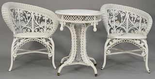 Four piece wicker lot including pair of chairs, round table dia. 22", and two tier stand (seat of one chair as is).
