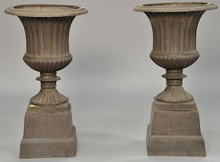 Pair of two part iron urns