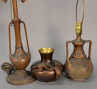 Two Art Nouveau bronze and copper lamps along with a vase having two baby figures on it