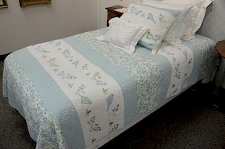 Three custom embroidered twin size quilts with two sets of embroidered sheets and pillows.