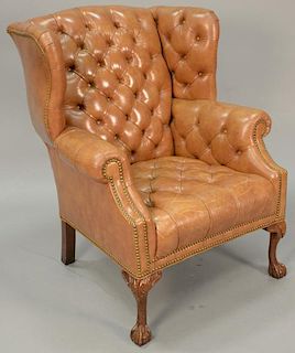 Leather tufted wing chair.
