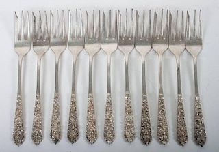 Eleven Mexican repousse silver seafood forks