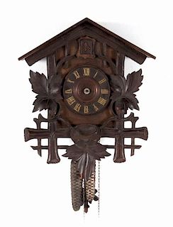German carved walnut or oak cuckoo clock