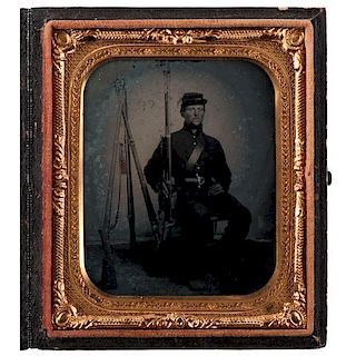 Sixth Plate Ambrotype of Armed Private Seated Beside Stacked Arms 