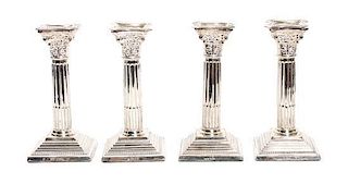 Four English Silver Candlesticks, DJ Silver Repair, London, 1965, having Corinthian column form on square bases.
