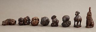 Group of Eight Carved Wood Netsukes, 20th c., in t