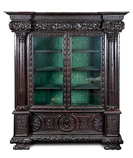 * A Continental Carved Oak Display Cabinet Height 86 1/4 x width 70 x depth 25 1/2 inches.