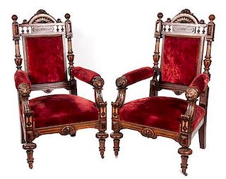 * A Pair of Victorian Ebonized Carved and Parcel Gilt Open Armchairs Height 46 inches.