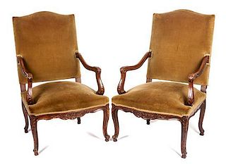 * A Pair of Victorian Carved Walnut Open Armchairs Height 44 1/4 inches.