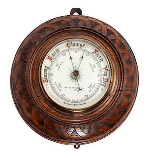 * An English Oak Cased Aneoid Barometer Diameter 10 inches.