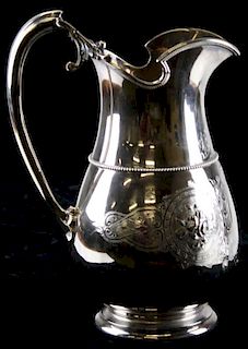 Gorham Mfg Co (1864-69) sterling silver water pitcher with circular foot. Baluster form with helmet