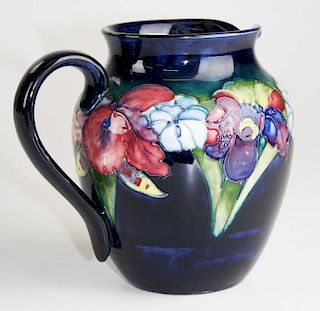 Moorcroft art pottery pitcher with iris floral decoration 7" x 7"