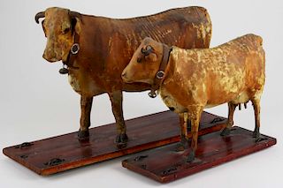 2 late 19th c wood & composition cow pull toys on grain painted wooden bases, some drying, cracking
