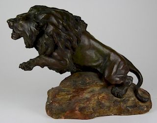 after Antoine-Louis Barye (French 1795-1875) bronze lion on plaster base, length 21”