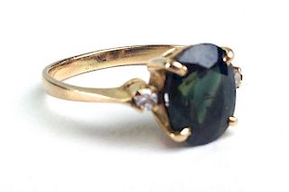 Y.g. ring with oval cut green tourmaline measuring 9.2mm x 7.2mm x 4mm with 2 small rd. cut diamonds