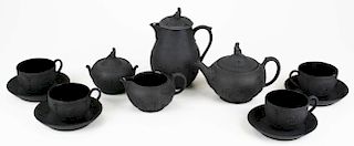 12 pc Wedgwood black basalt pottery tea set incl. four cups and saucers, sugar and creamer, coffee a