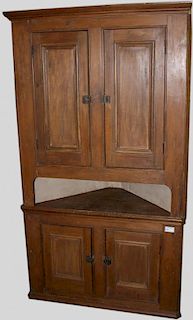 Quebec pine two part corner cupboard having two drawers over two doors. 85"h x 48"w x 23"d.