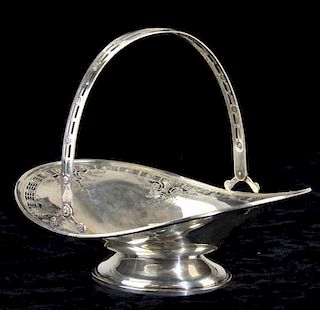 Dominick & Haff sterling silver swing handle basket with floral motif. Oval boat shape, footed. Mark