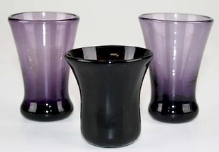 three early amethyst blown 'thumper' whiskey/ cordial glasses with pontil marks