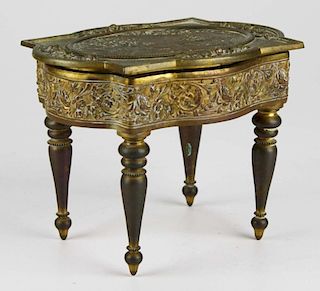 French gilt brass table form dresser jar, engraved scenic panel on top, lined in velvet, 7” x 5.5” 5