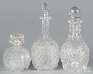 Three cut glass decanters, tallest - 10 3/4''.