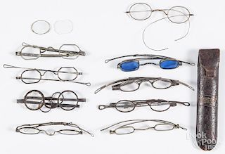 Nine pairs of antique spectacles, to include a silver example, marked Wolf.