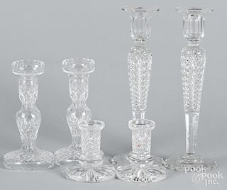 Three pairs of cut glass candlesticks, one pair marked Waterford, 4 1/4'' h., 8'' h., and 12'' h.